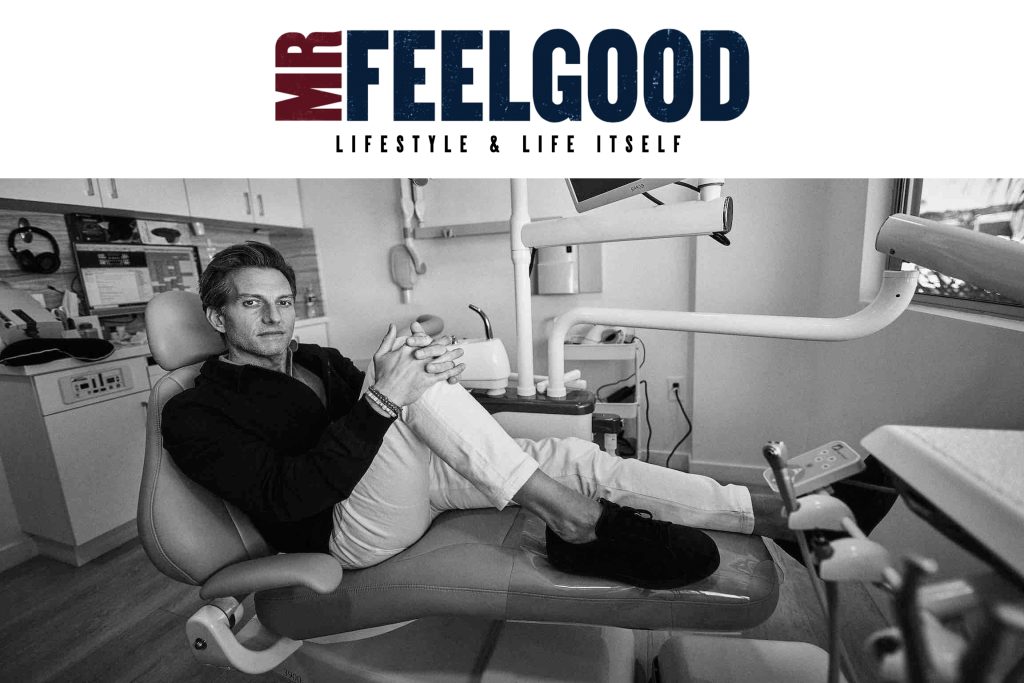 A man sits comfortably on a dental chair in a dental office setting. He is casually dressed and looking towards the camera. The image is in black and white, with MR FEELGOOD written above, followed by LIFESTYLE & LIFE ITSELF.