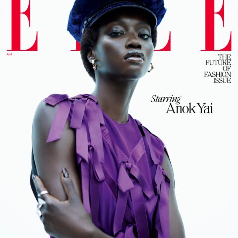 A model poses on the cover of Elle magazines The Future of Fashion issue. She wears a purple top with ribbon details and a navy cap. Text reads Starring Anok Yai. The background is white.