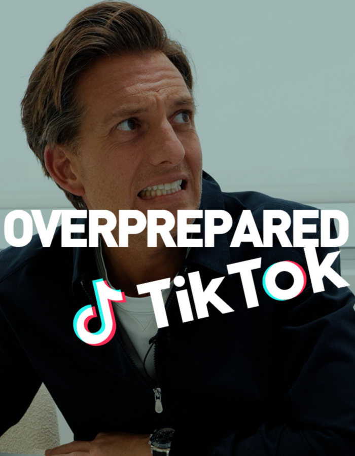 Man with a concerned expression sits at a desk with hands near a keyboard. The text OVERPREPARED TikTok is overlaid on the image.